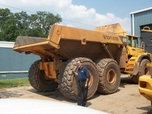 Mechanic next to big truck - NexTire Commercial